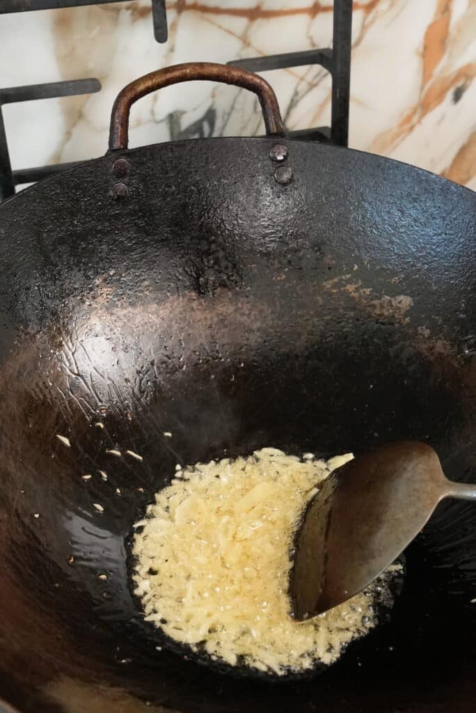 frying garlic in a wok
