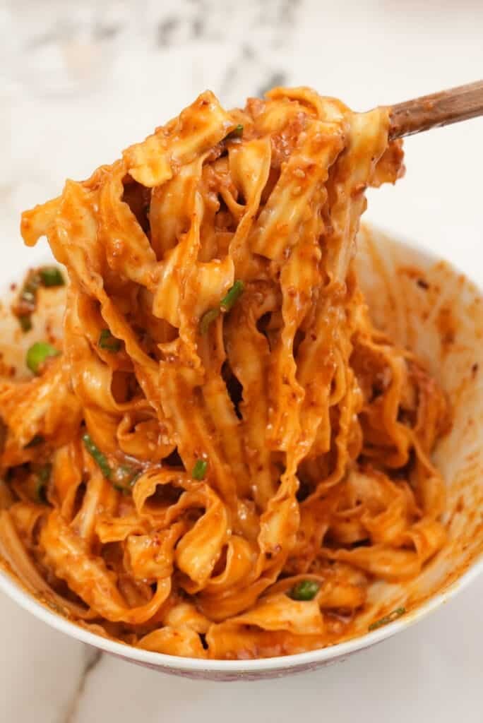 Spicy gochujang noodles in a bowl.