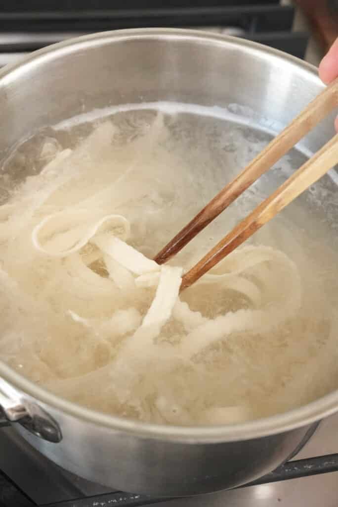 Cooking noodles in boiling water.