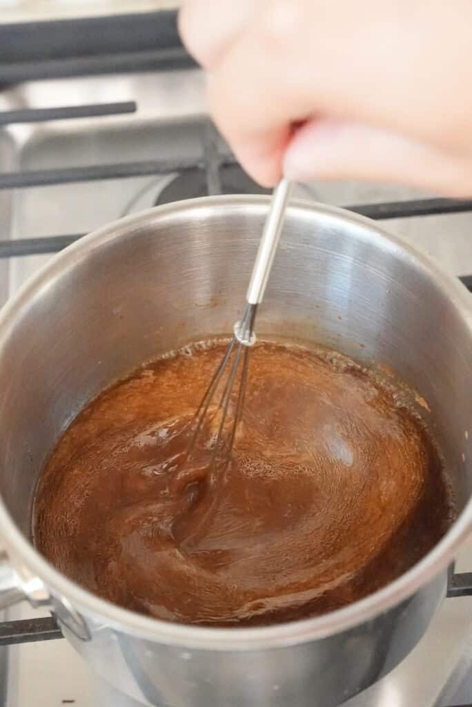 mixing oyster sauce in a pan