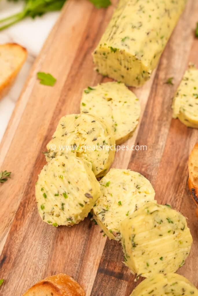 close up of sliced compound butter on a cutting board