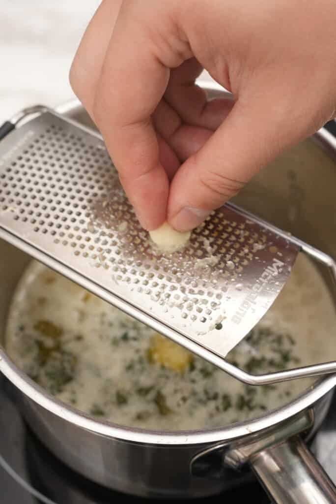 Grating garlic for the herb butter.