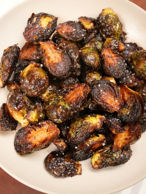 Crispy roasted brussels sprouts in a ceramic bowl.