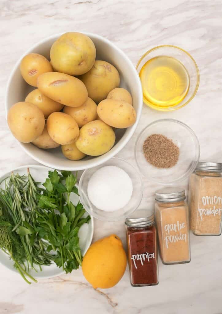 Raw ingredients for crispy smashed potatoes on a table.