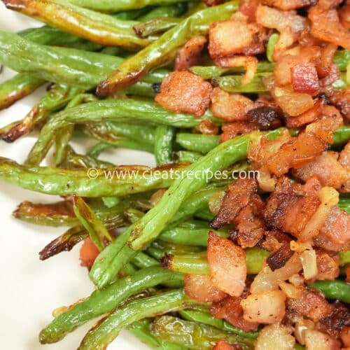 close up of roasted green beans with bacon