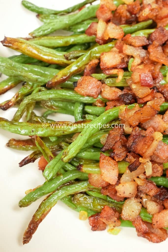 close up of roasted green beans with bacon