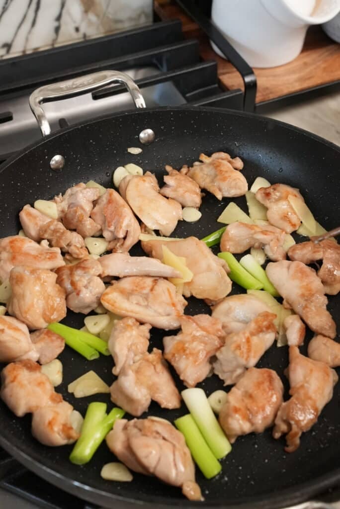 cooking chicken with garlic and ginger and scallions