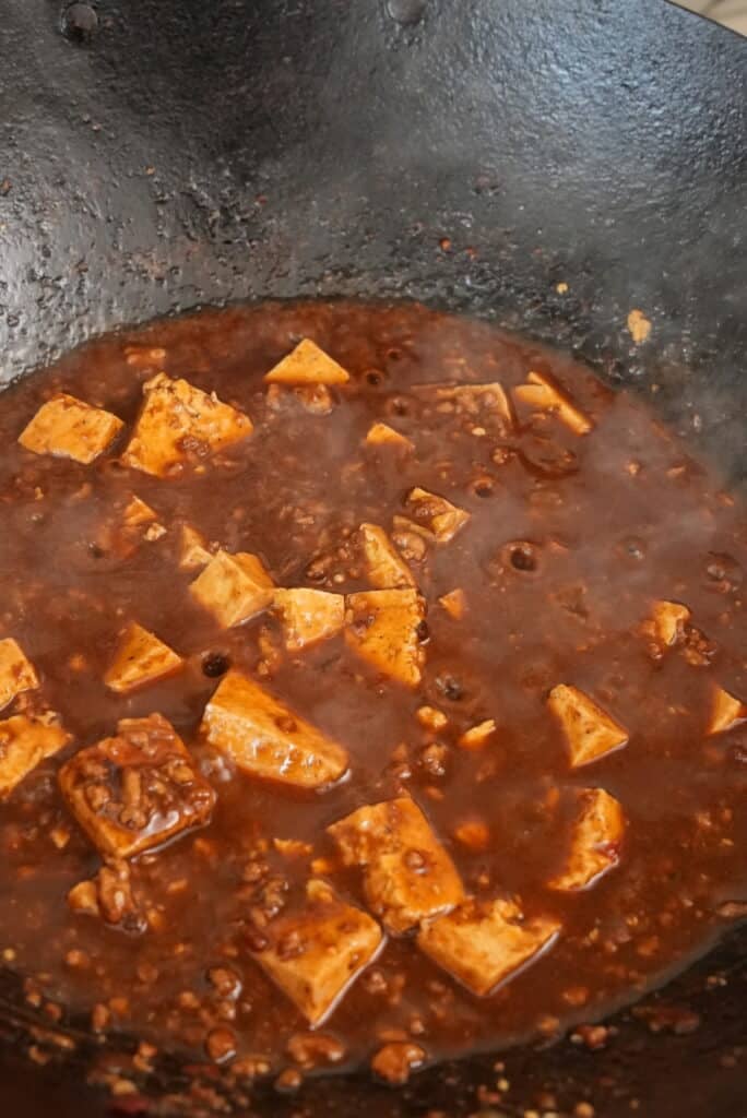 mapo tofu boiling in a wok