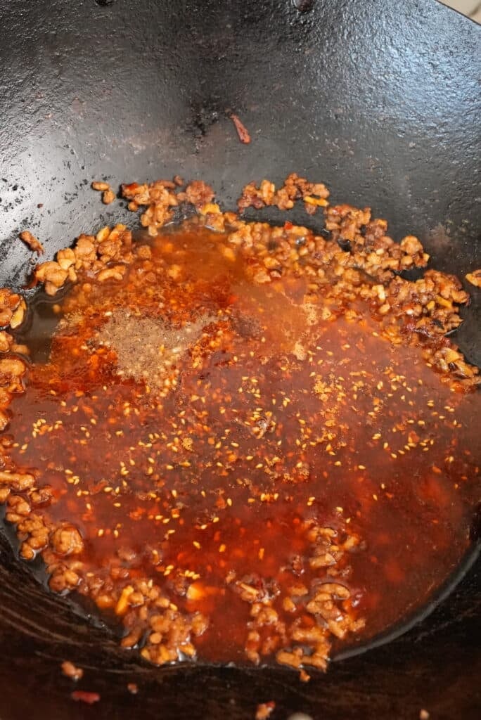 mapo tofu cooking in a wok