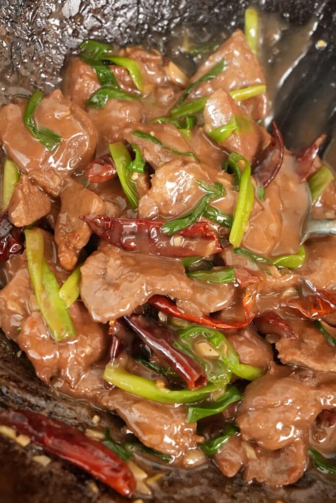 close up of mongolian beef in a wok