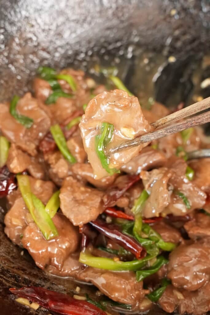 Mongolian beef cooked in a wok.