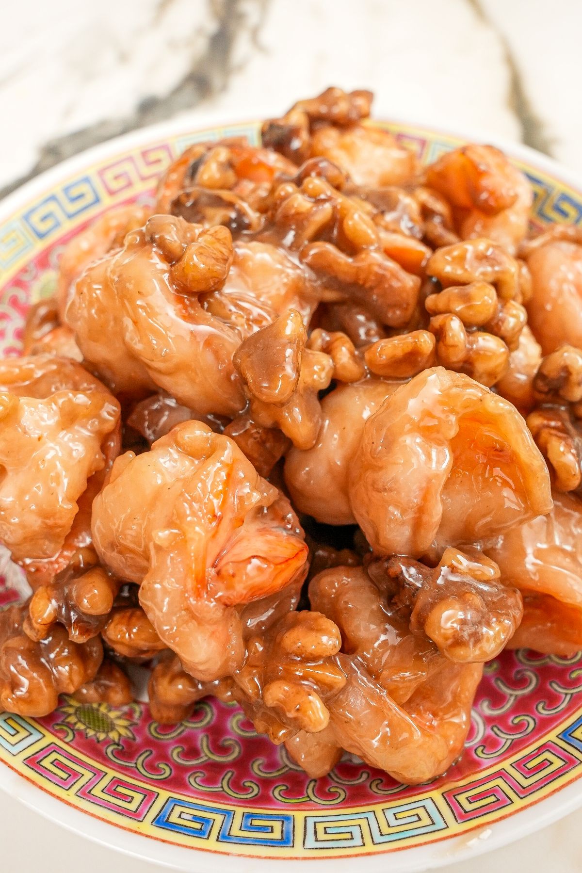 Honey Walnut Shrimp on a plate with candied walnuts.