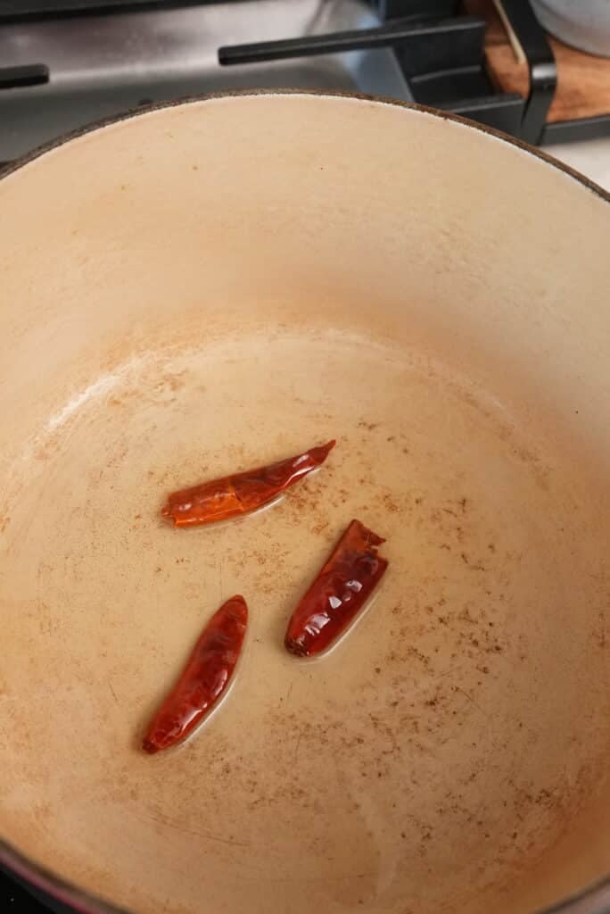 frying chili peppers in oil