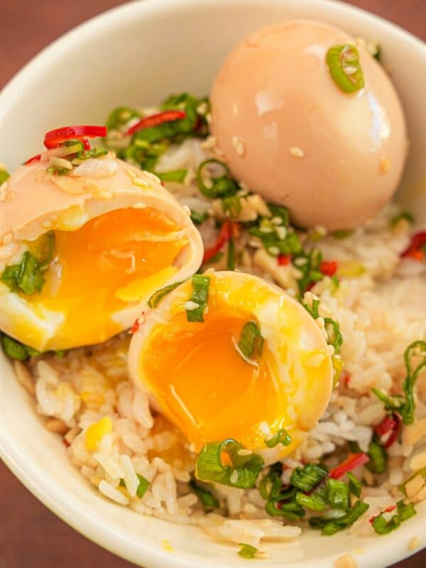 Korean Marinated Eggs (Mayak Eggs) over rice in a bowl.