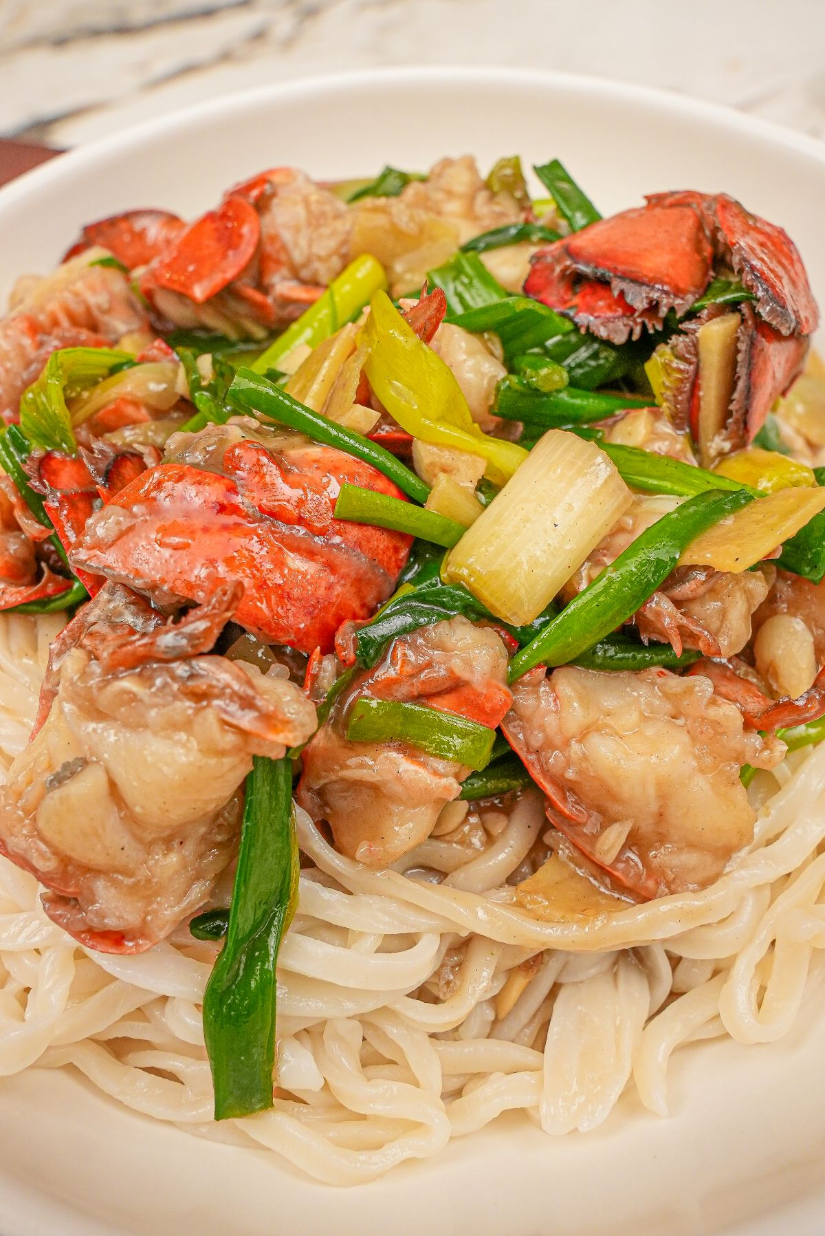 Chinese Lobster noodles (Lobster Yee Mein) in a large white bowl.