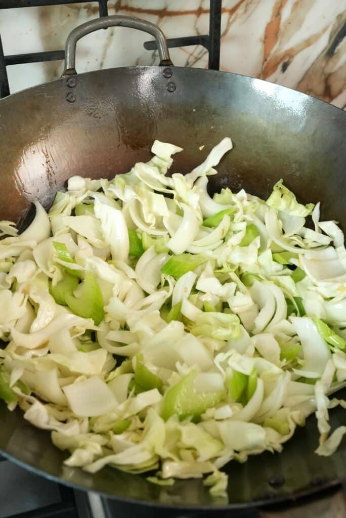 Stir fried cabbage and celery in a wok