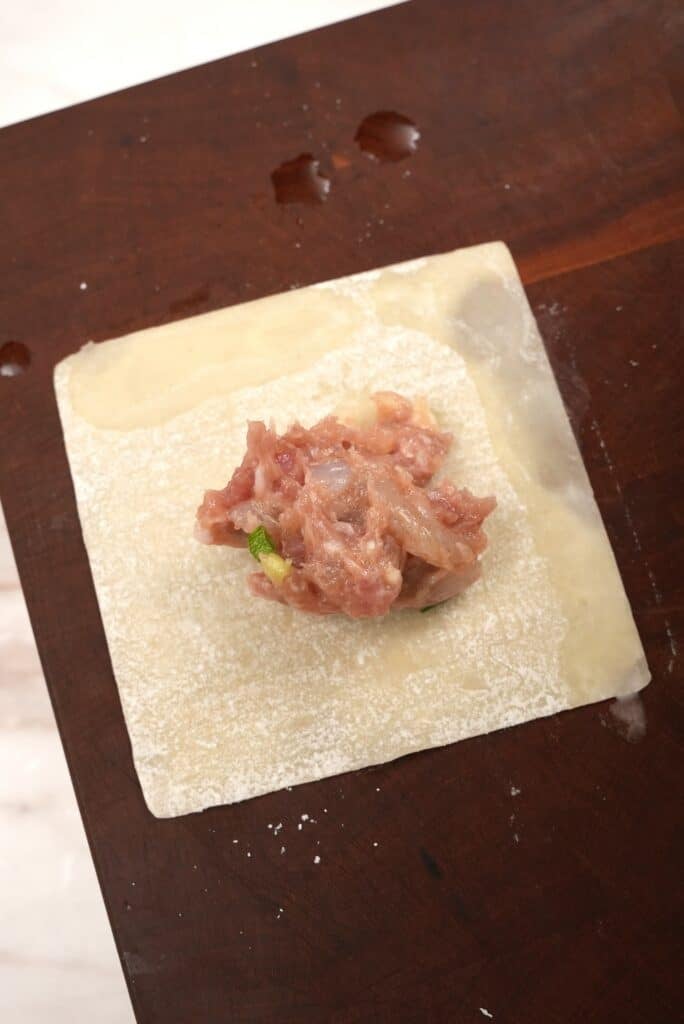 Pork and shrimp filling in a wonton wrapper.