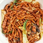 A bowl of Shanhai Fried Noodles in a bowl with bok choy, mushrooms, and pork.