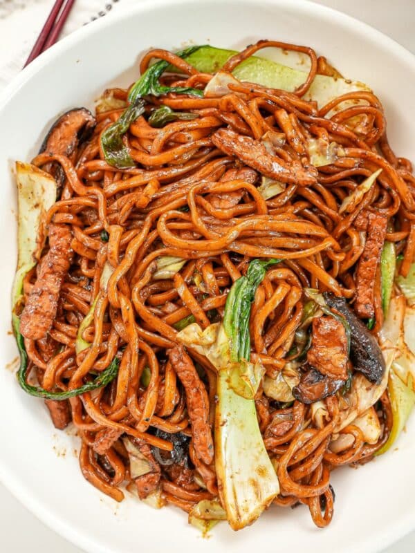 A bowl of Shanhai Fried Noodles in a bowl with bok choy, mushrooms, and pork.