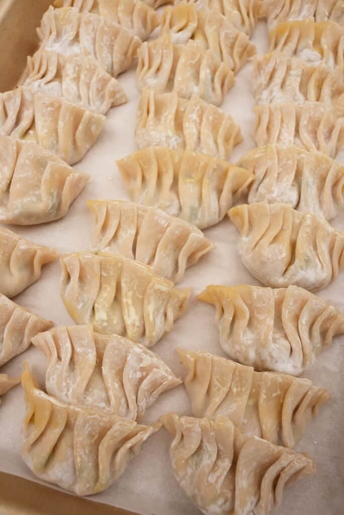 folded dumplings on a tray