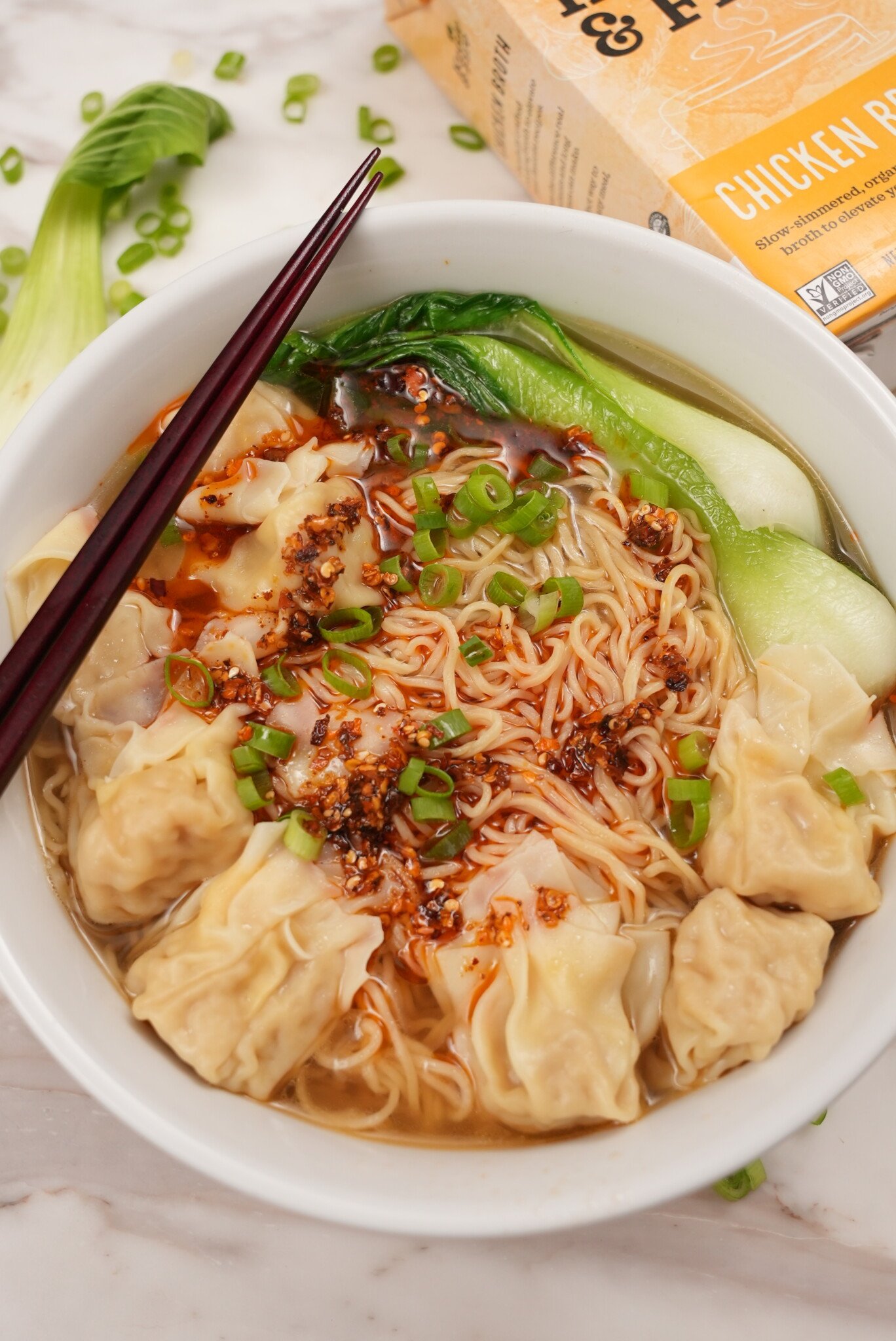 Wonton Noodle Soup in a bowl with bok choy and chili oil