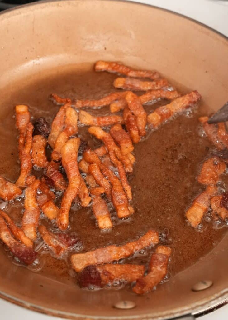 Guanciale frying in a pan