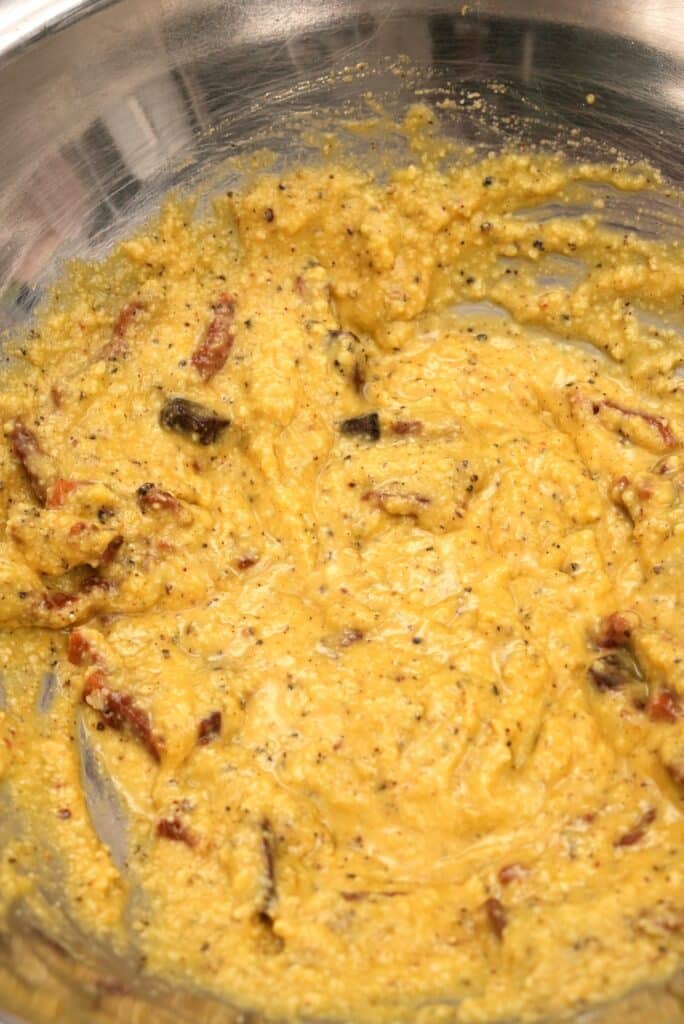 Eggs, cheese, and pepper mixed in a bowl
