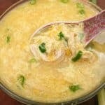 Chicken Corn Egg Drop Soup in a bowl with a spoon.
