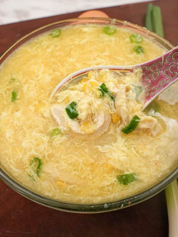 Chicken Corn Egg Drop Soup in a bowl with a spoon.