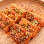 Korean braised tofu (Dubu Jorim) on a wooden bowl.