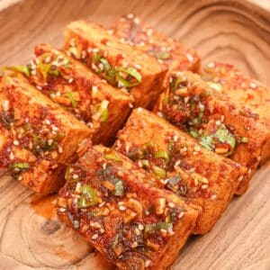 Korean braised tofu (Dubu Jorim) on a wooden bowl.