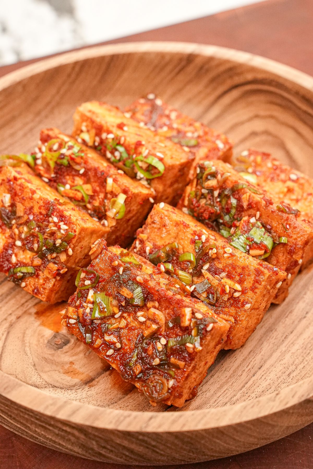 Korean braised tofu (Dubu Jorim) on a wooden bowl.