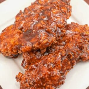 A plate of Korean Honey Butter Fried Chicken stacked on top of each other.