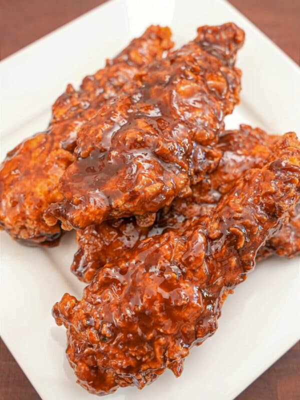 A plate of Korean Honey Butter Fried Chicken stacked on top of each other.