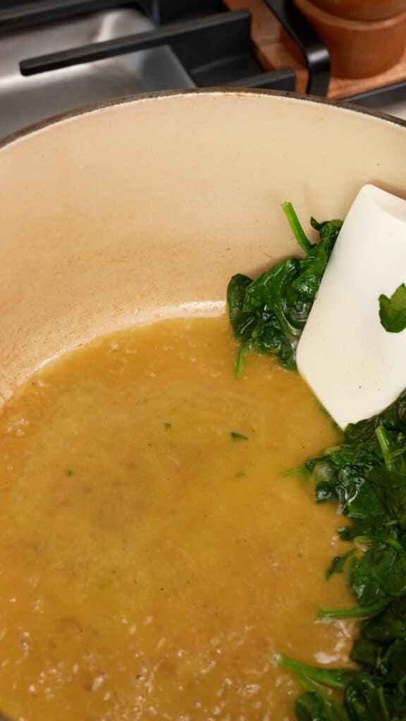 Cooking spinach in a pot.