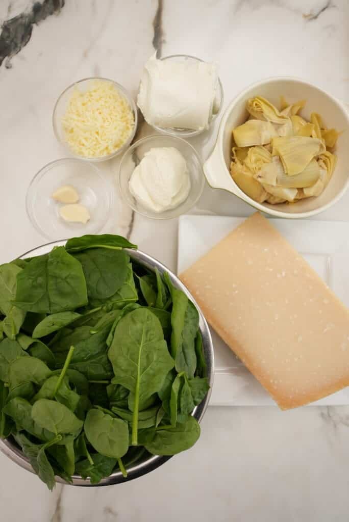 Raw Ingredients for Spinach Artichoke Dip on a table