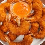 Coconut Shrimp on a plate with sweet chili sauce.