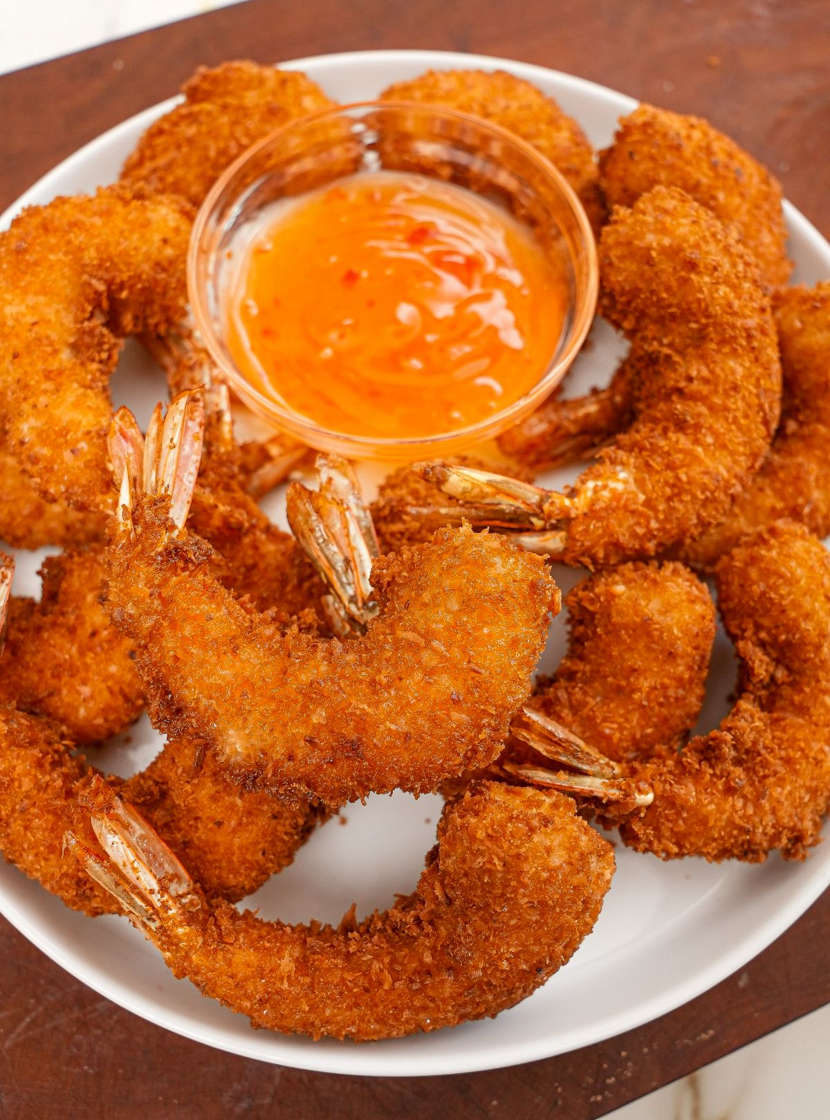 Coconut Shrimp on a plate with sweet chili sauce.