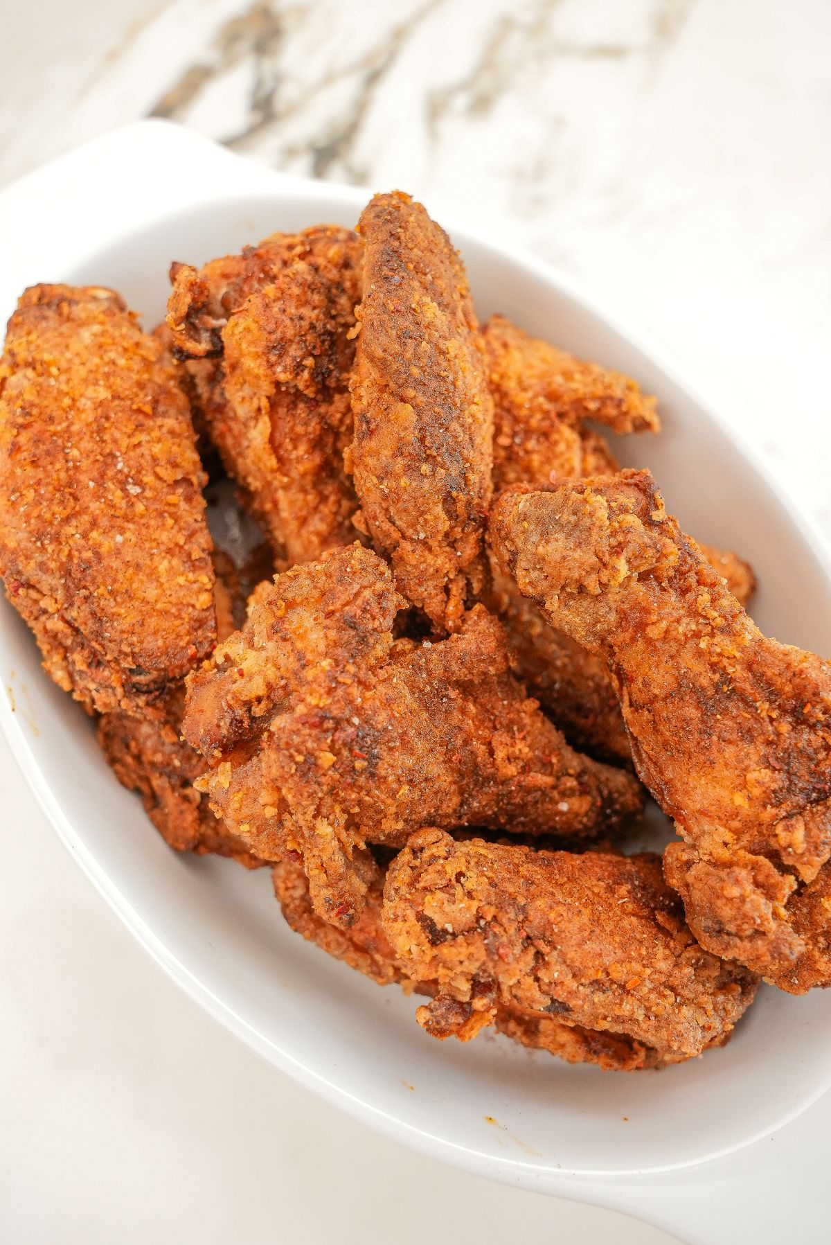 Crispy Five Spice Chicken Wings on a white tray.