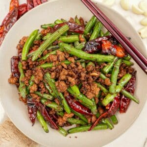 Chinese Green Beans with Pork in a bowl with chopsticks.