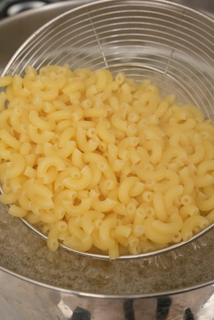 Cooked macaroni in a pot of salted water