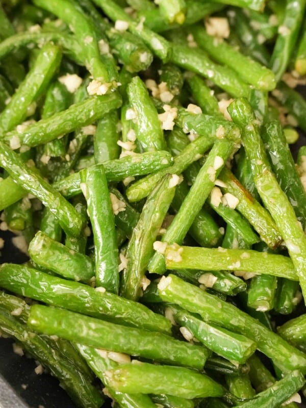 Green Beans tossed with garlic and spices in a pan