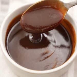 Authentic Homemade Tonkatsu sauce in a bowl with a spoon.