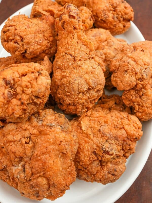 A plate of crispy fried chicken pieces on a white plate.