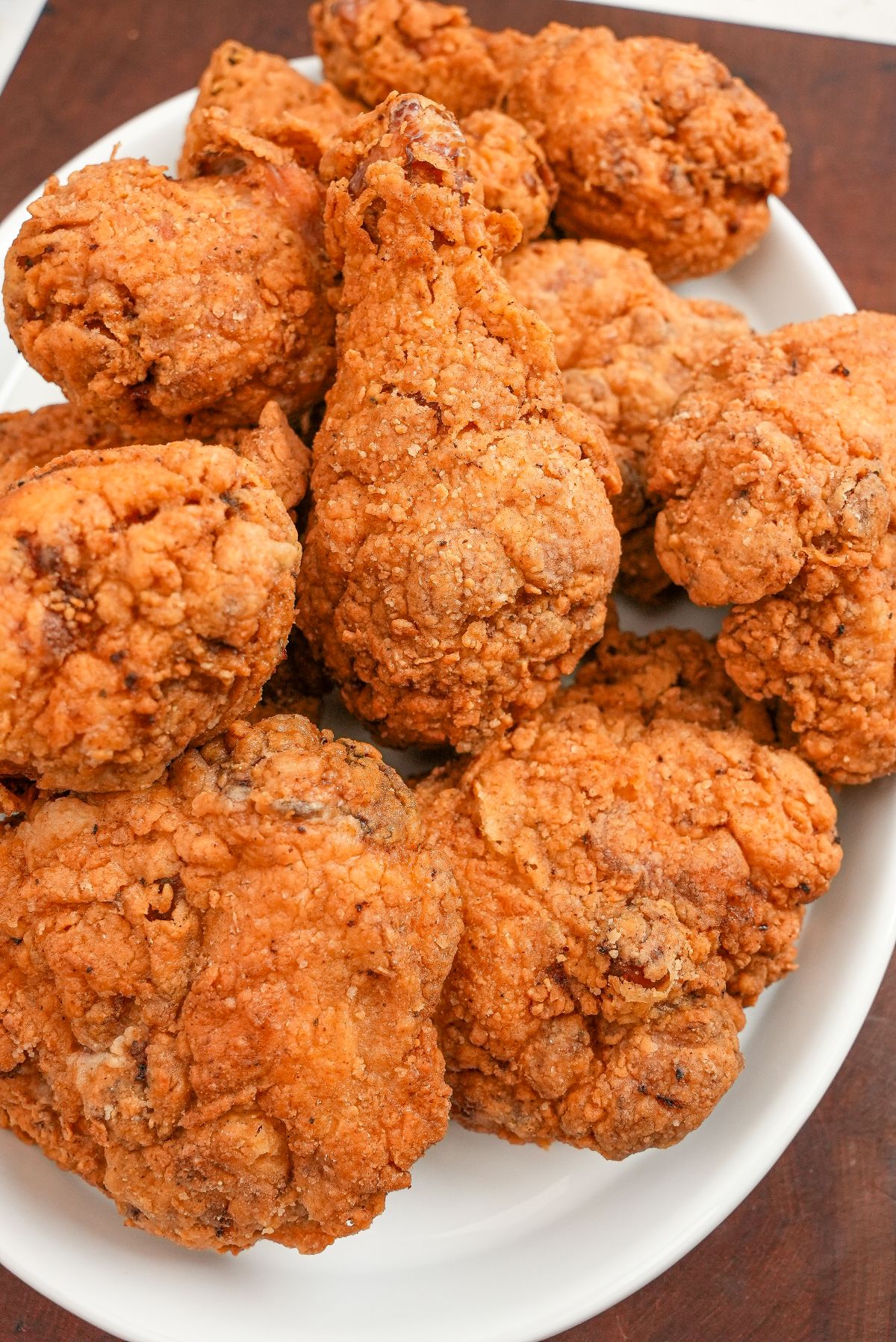 A plate of crispy fried chicken pieces on a white plate.