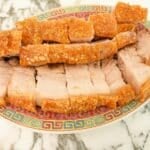 Air fryer crispy pork belly cut up on a plate.