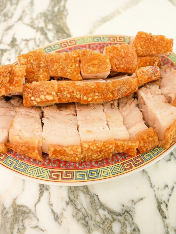 Air fryer crispy pork belly cut up on a plate.