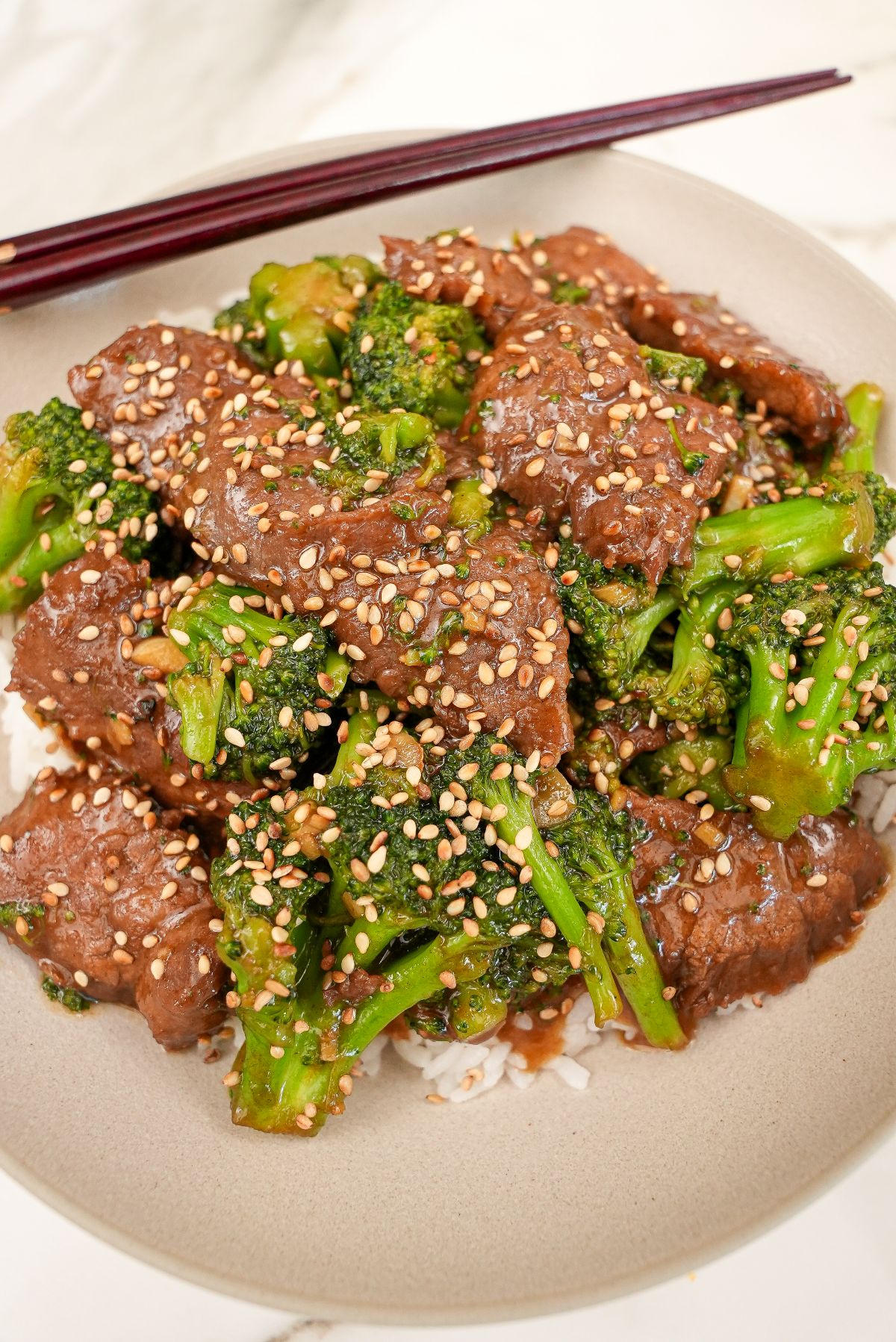 An authentic Beef and Broccoli in a bowl with white rice.