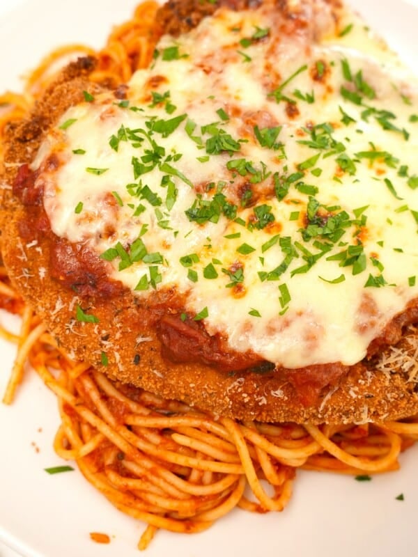 Crispy Chicken Parmesan plated on spaghetti and sauce