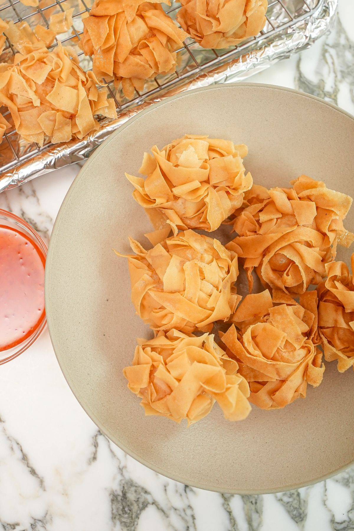 Dim Sum Crispy Fried Shrimp Balls on a plate next to sweet and sour sauce.